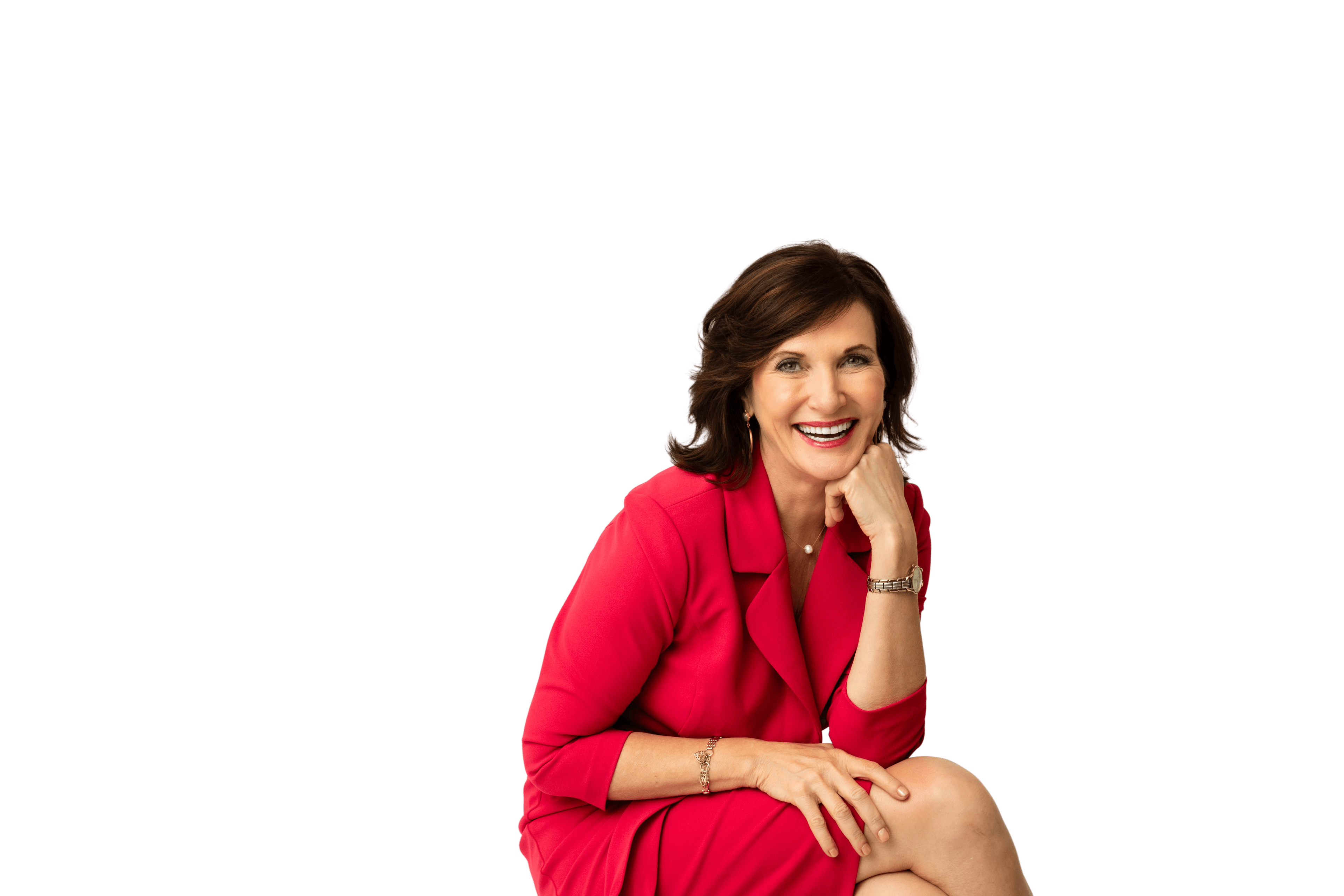 Dr. Margie Warrell in a red blazer, chin resting on her hand, smiling to camera